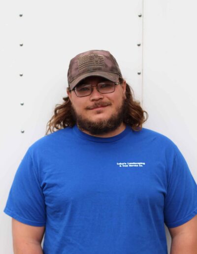 Will smiling in blue Luke's Landscaping shirt