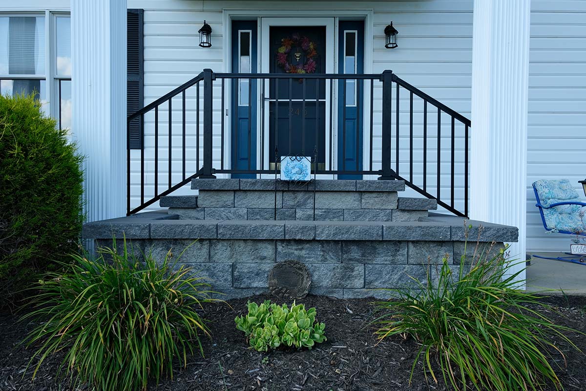 Front door steps with railing Concrete Outdoor Stairs going up a hill