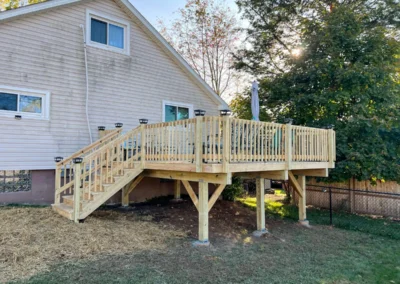 raised wooden deck attached to home
