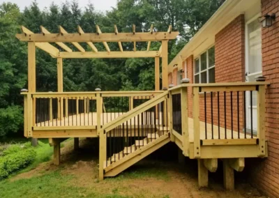 wood deck with pergola and black railings and hardware