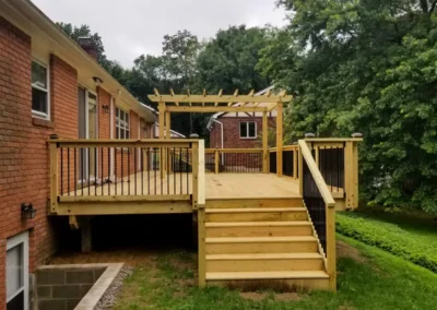 wood deck with pergola attached to a home