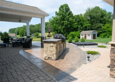 paver patio with an outdoor grill sitting on it