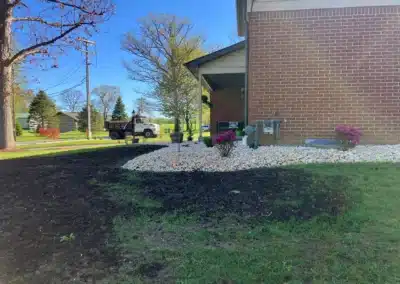dirt patch with grass seed by a home